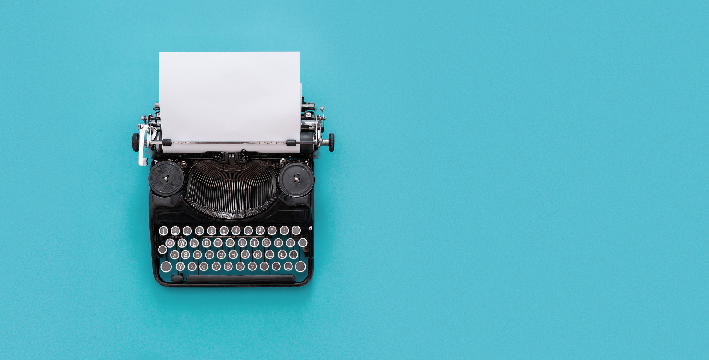 Vintage typewriter on blue background